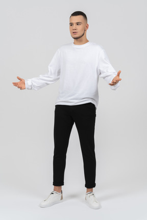 Excited young man in casual clothes gesturing