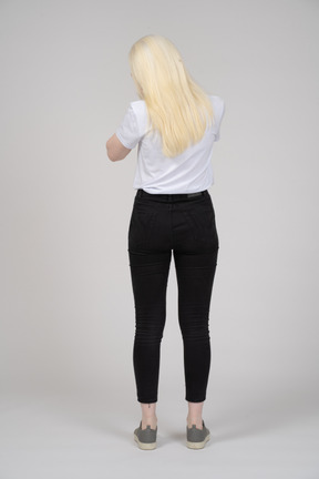 Back view of a long-haired woman standing