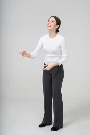 Front view of a young woman in suit looking up