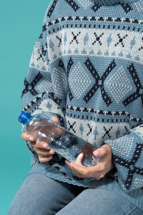 Holding a bottle of mineral water