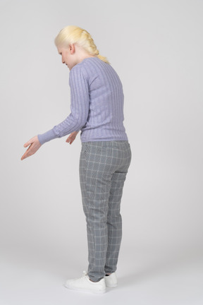 Three-quarter back view of a woman leaning forward and gesturing