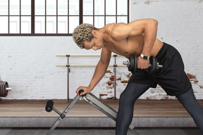 A man is doing exercises with a barbell