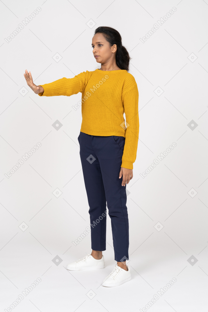 Cute girl in casual clothes showing stop gesture