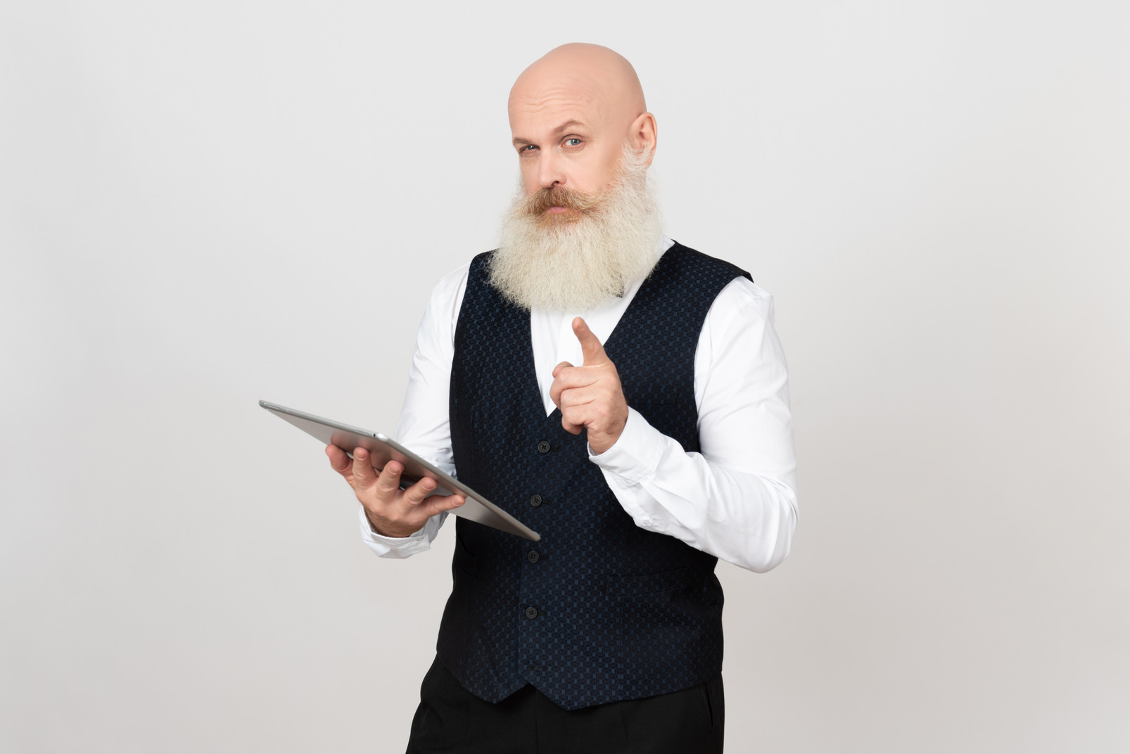Aged man holding tablet and pointing something out