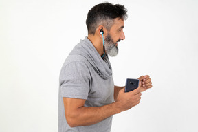 Mature man listening to music while running