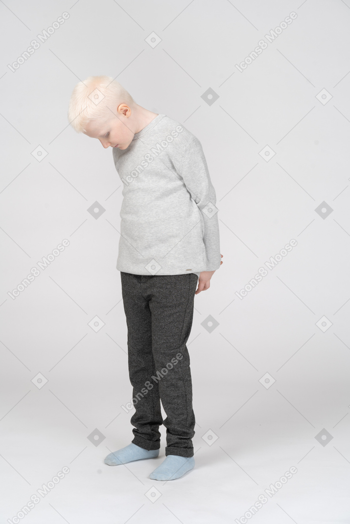 Three quarter view of a shy little boy