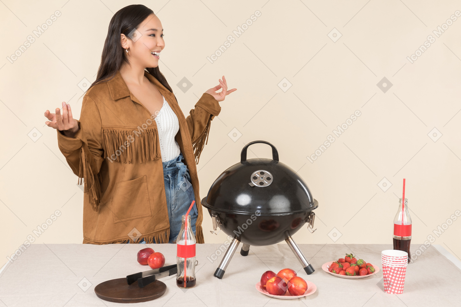 Young asian woman standing near closed grill on the table