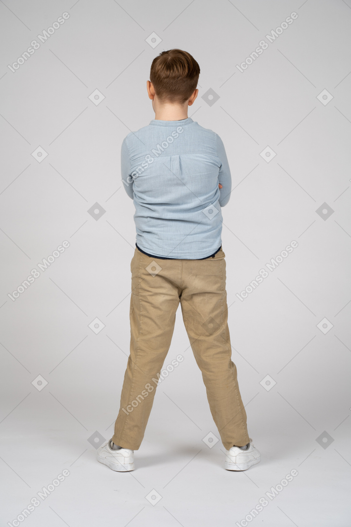 Rear view of a boy standing still
