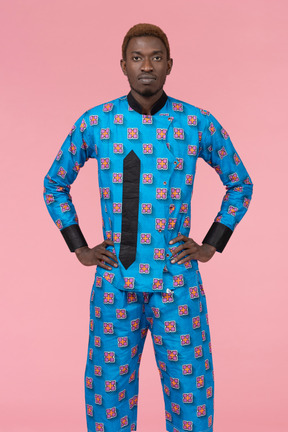 Black man in blue pajamas looking at camera