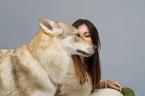 Side view of a dog and her female patient on the background