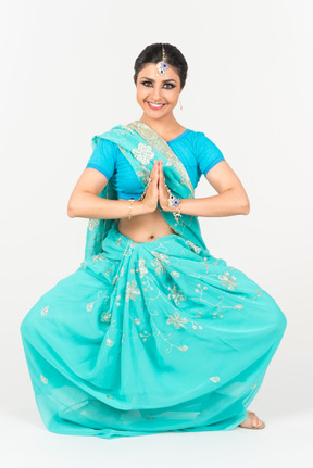 Young indian dancer standing in dance position with her hands folded