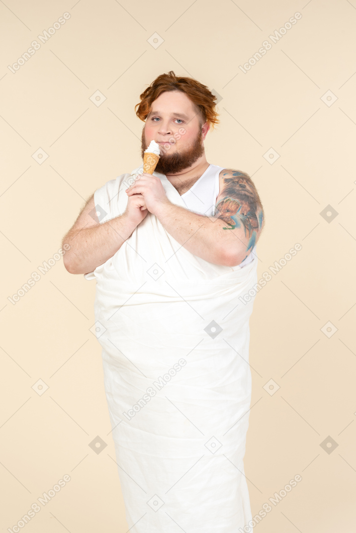 Big man dressed as a cupid eating ice cream