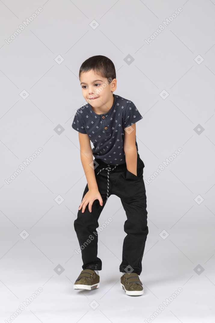 Front view of a cute boy squatting