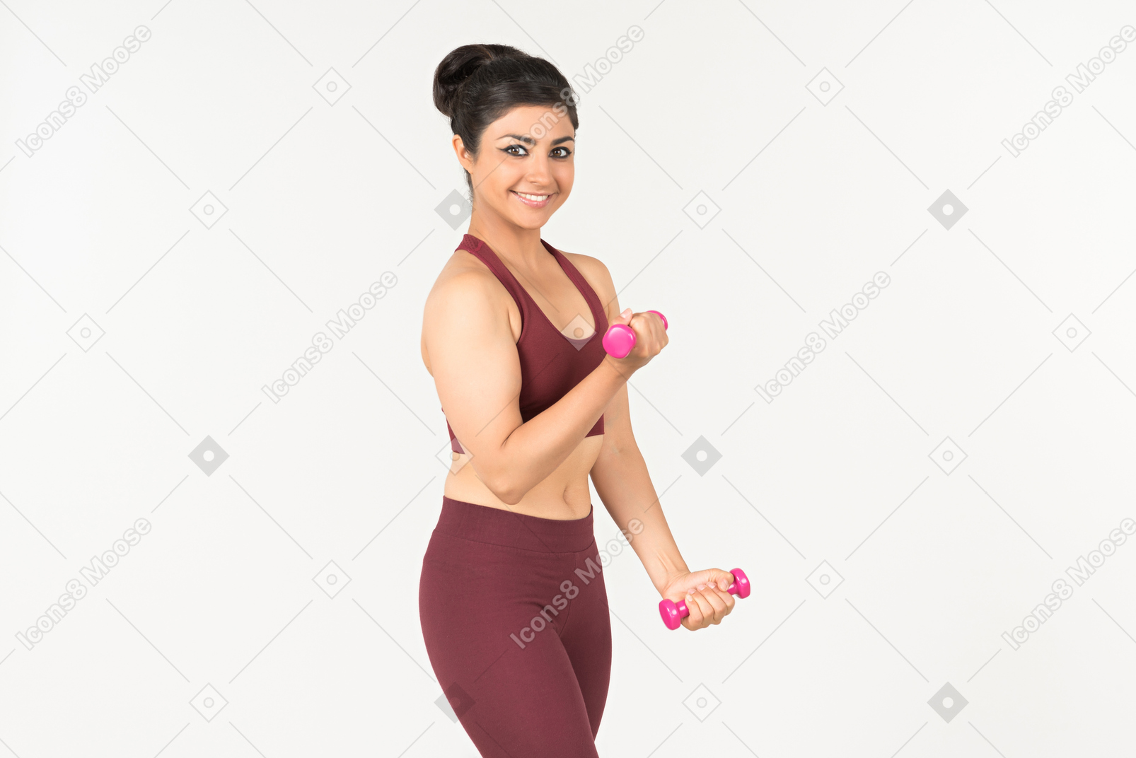 Young indian woman in sportswear lifting hand weights