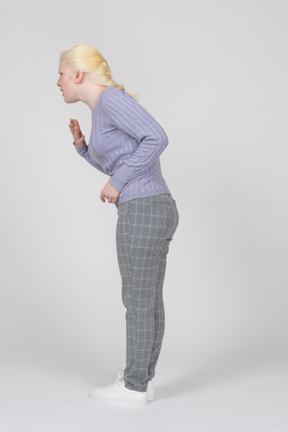 Side view of young woman bending down