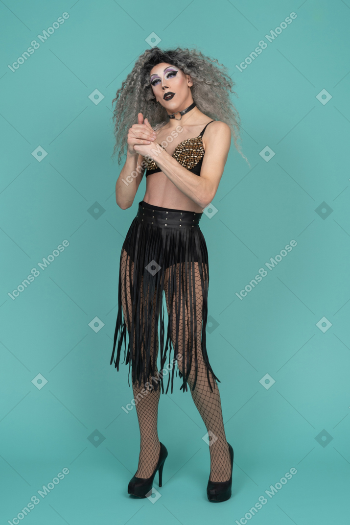 Drag queen standing with hands locked together