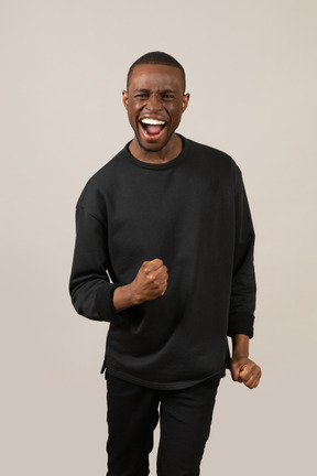 Front view of excited young man