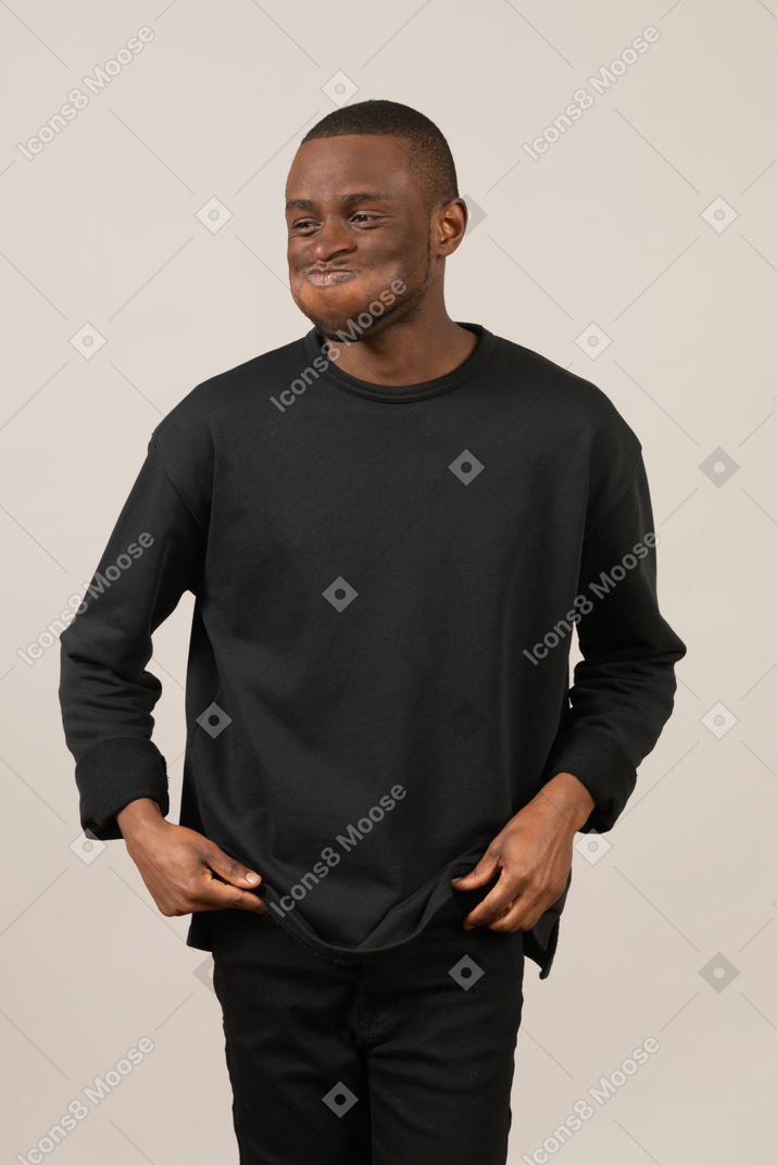Young man trying not to laugh