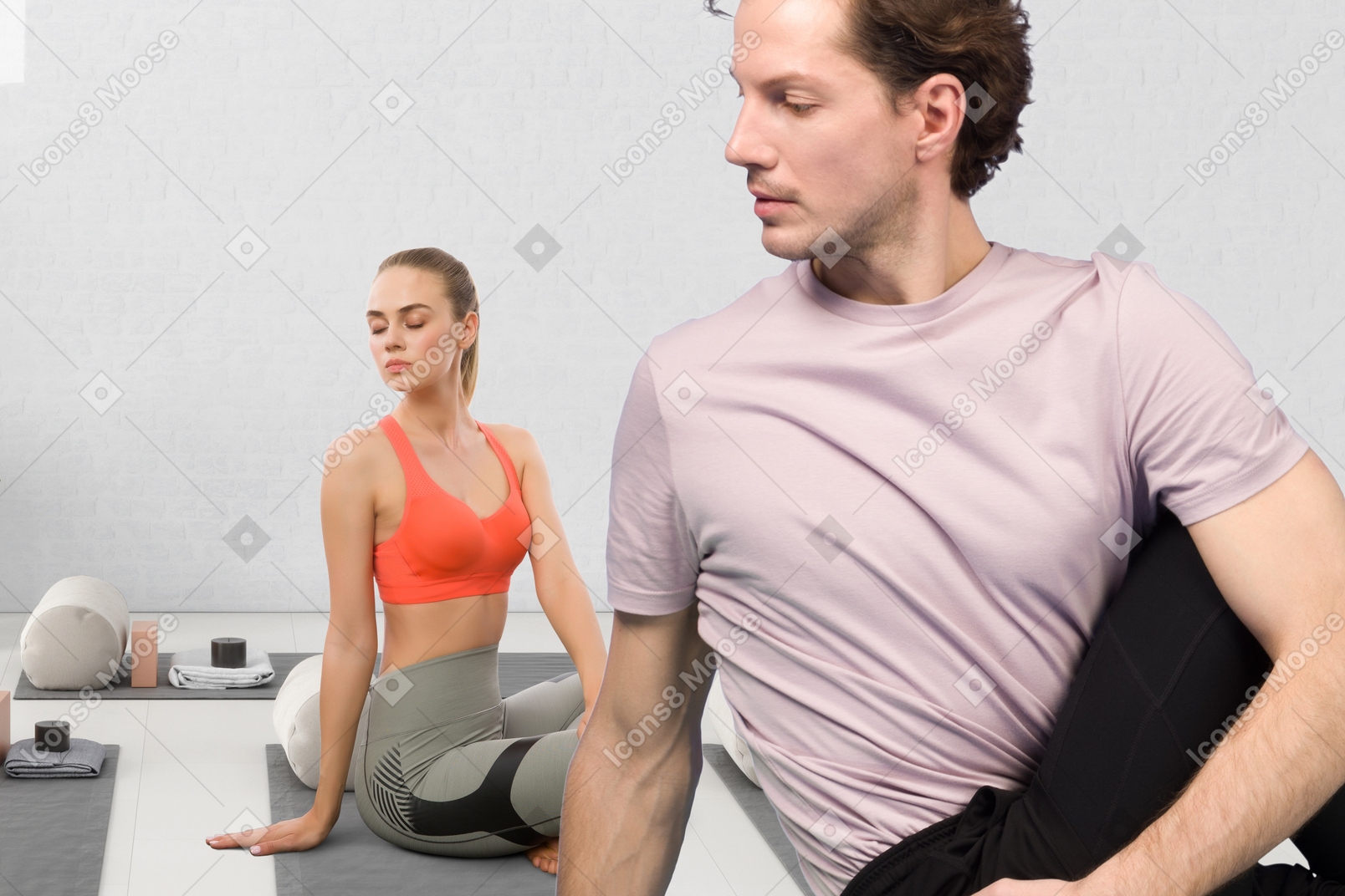 A man and a woman doing yoga in a room