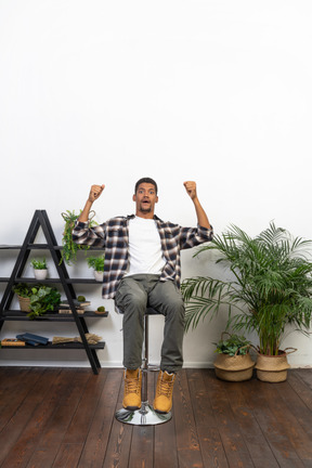 Good looking young man sitting on a chair