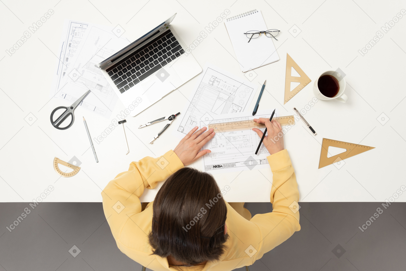 A female architect working on architectural drawings