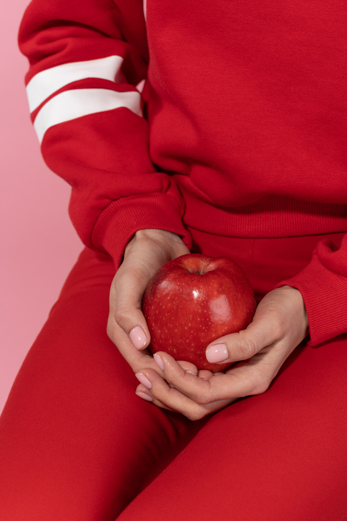Holding red apple in hands