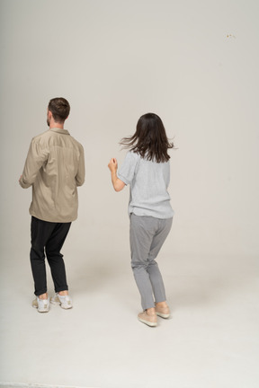 Young man and woman standing with bent knees