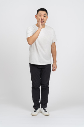Front view of a man in casual clothes calling someone