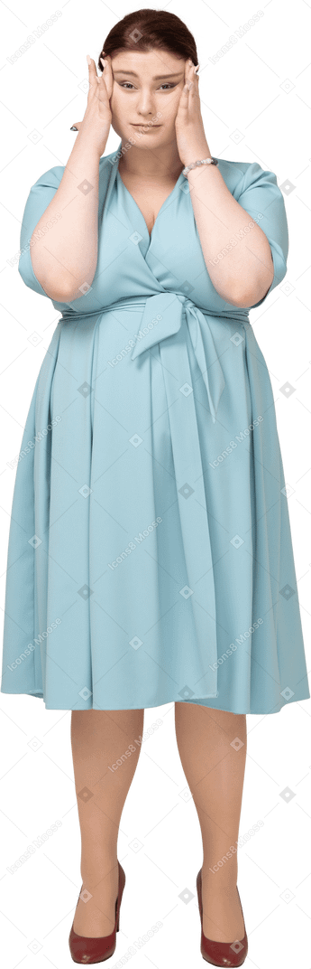 Front view of a woman in blue dress touching head