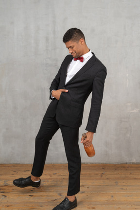 Young man walking with hand tucked into his suit jacket