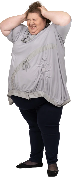 Smiling woman holding her head