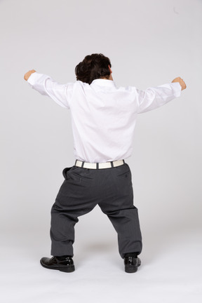 Back view of an office worker cheering