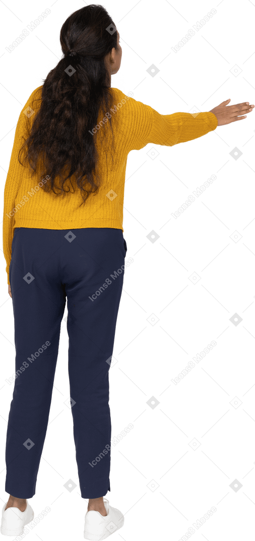 Rear view of a girl in casual clothes showing direction