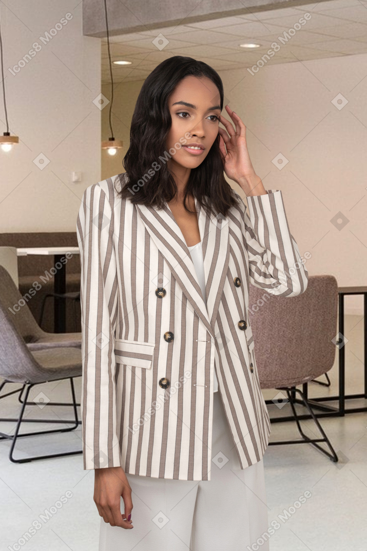 A woman in striped blazer standing in the conference room