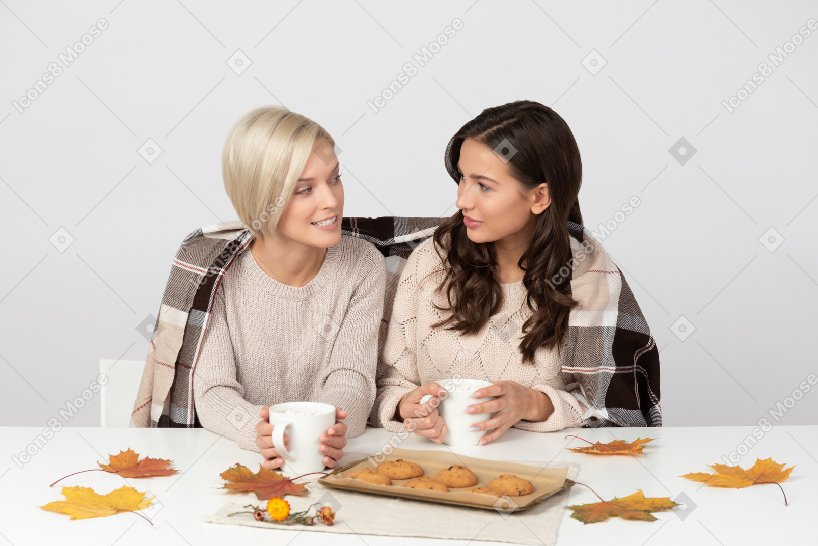 Young women drinking coffee and looking at each other