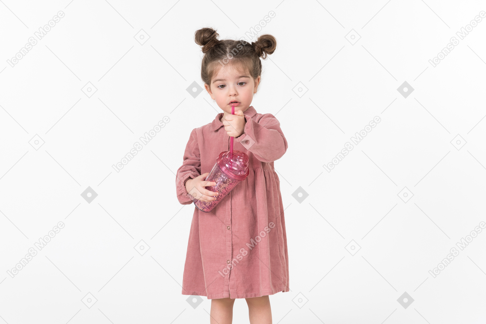 Little kid girl holding pink plastic cup and straw