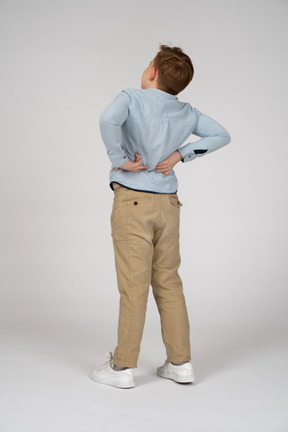 Back view of a boy stretching