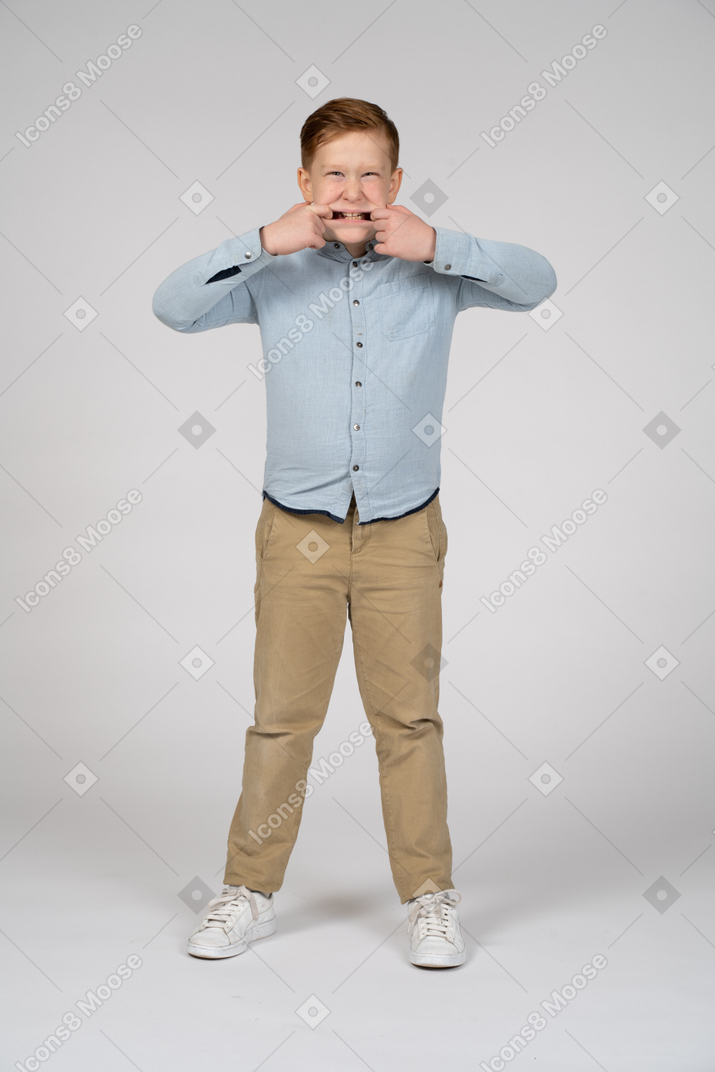 Front view of a cute boy making faces