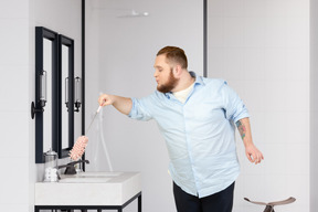 Young man cleaning the bathroom