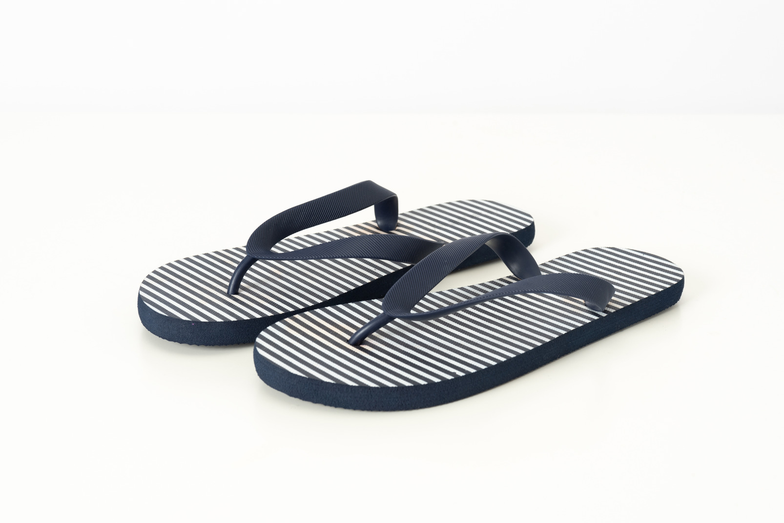 Blue and white flip-flops on a white background