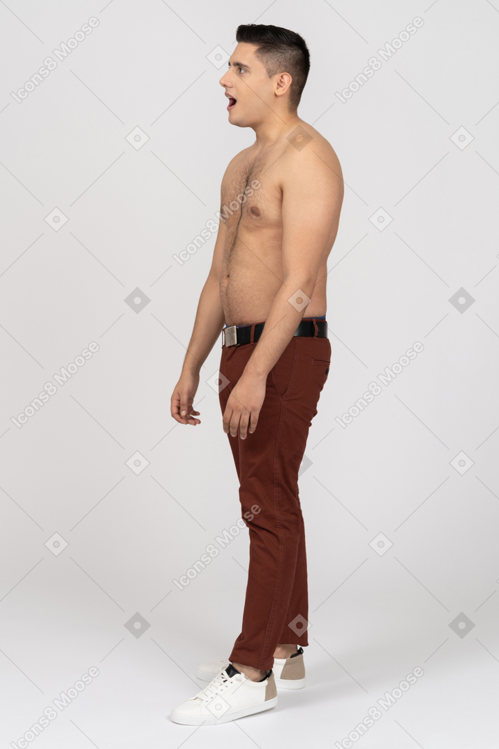 Side view of a shirtless latino man opening his mouth in surprise