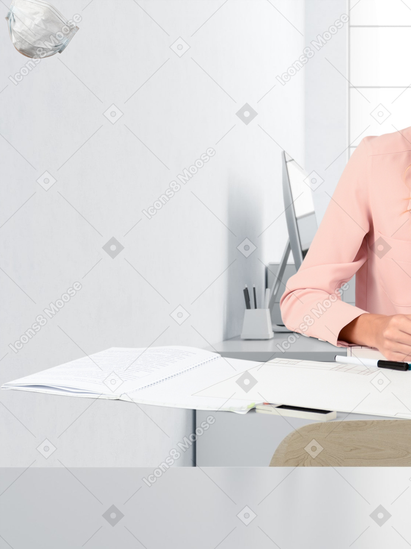 A woman sitting at a desk with a glass of water