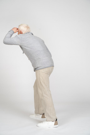 Man standing back to camera and looking into distance