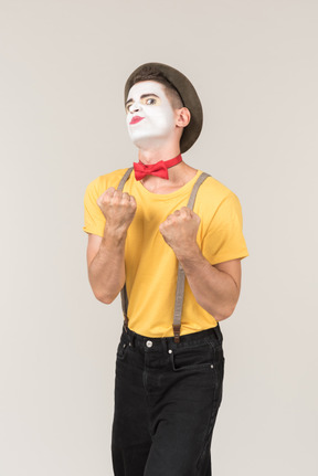 Male clown holding his fists up