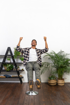 Good looking young man sitting on a chair