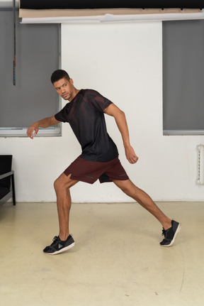 Young man in sports clothes posing