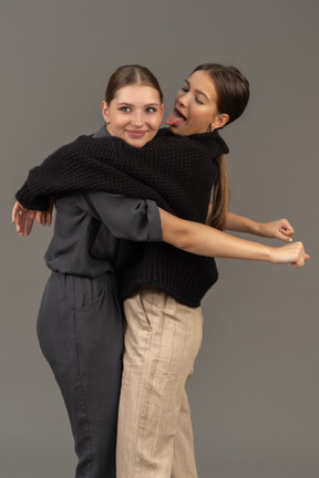 Two women hugging and fooling around