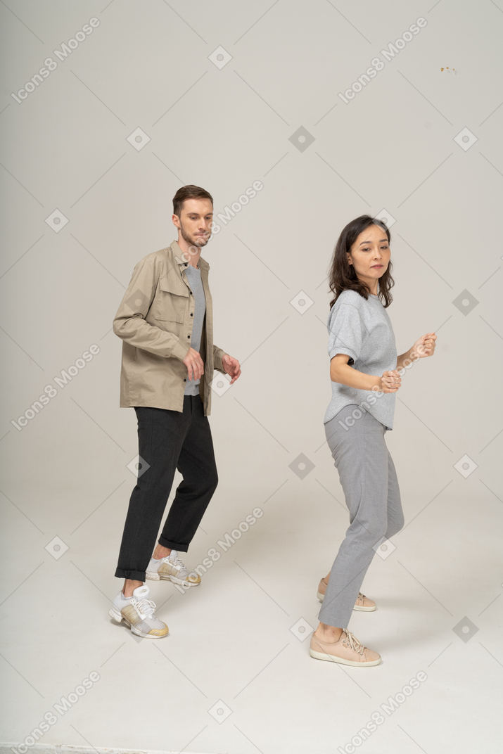 Young man and woman doing a dance move