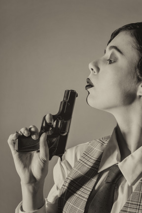 Woman blowing on the handgun