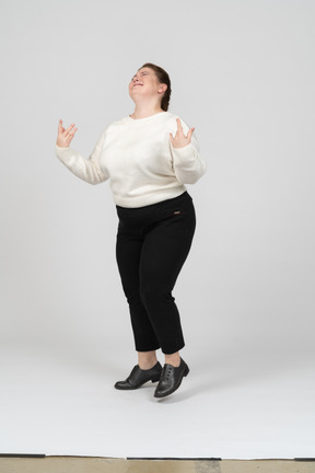 Cheerful plump woman in white sweater